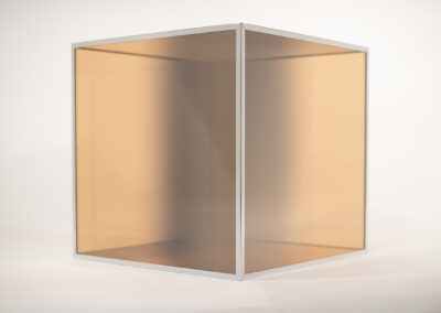 A minimalist, translucent cube with a white frame stands on a plain white background; its amber-tinted sides softly diffuse the light, reflecting the subtle, modern design ethos of Bell Mills 2025.
