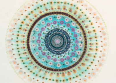 A colorful, intricate circular mandala by McConville Munroe features concentric rings of dots and patterns in shades of teal, blue, green, purple, and orange on a light background. The 2025 design has a delicate, symmetrical, and abstract appearance.