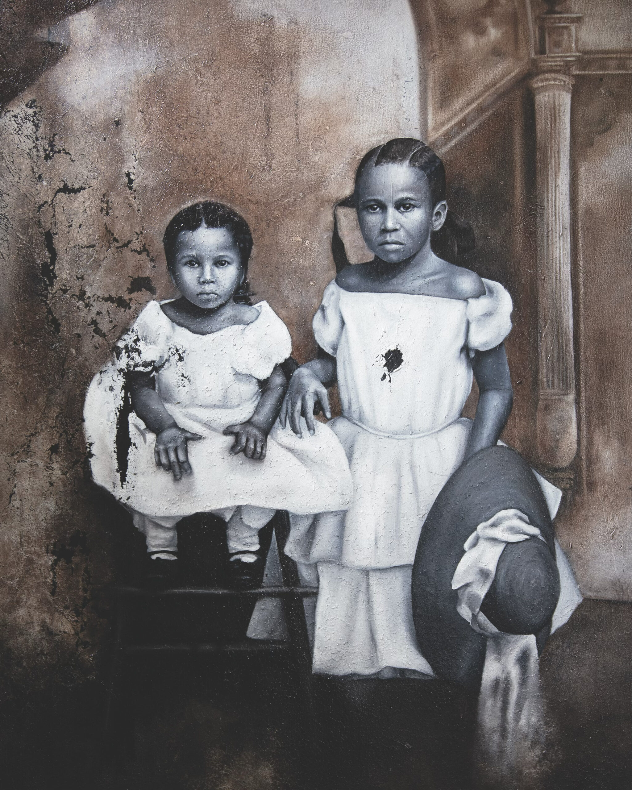 A sepia-toned painting of two young girls in white dresses, one seated on a chair and the other standing with a wide-brimmed hat in hand, against a textured, vintage wall backdrop.