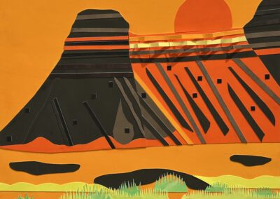 A colorful paper collage of a desert landscape featuring two dark mesas, an orange sun setting behind them, and layered orange sky and ground with green patches representing vegetation.